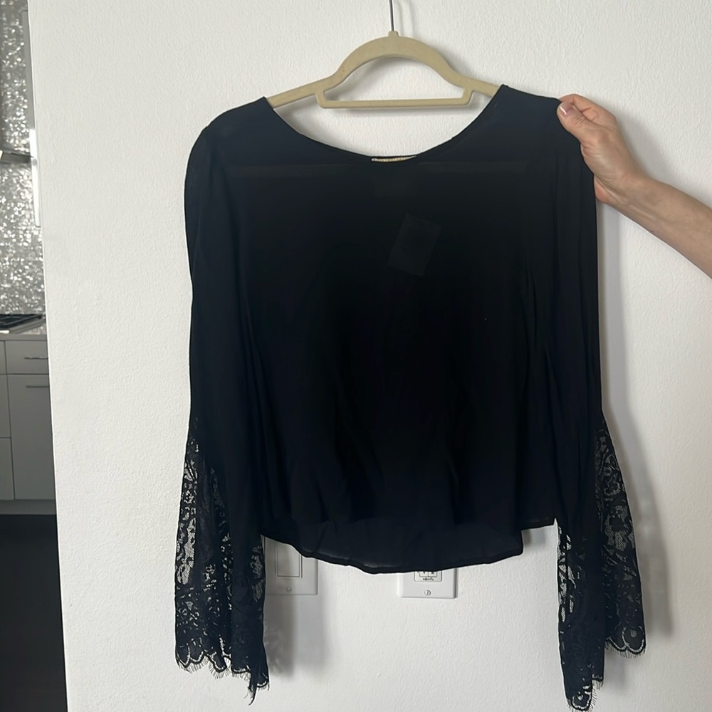 New Black long sleeve blouse size medium with intricate lace detailed sleeve